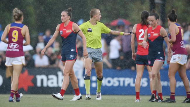 The umpire stops play during the AFLW clash between Melbourne and the Brisbane Lions due to nearby lightning strikes. Picture: Wayne Ludbey