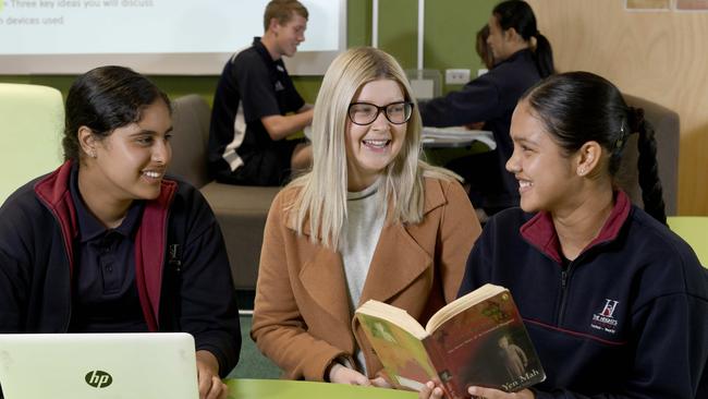 English teacher Tegan Gilson with year 9 students Angelpreet and Jiya at The Heights School in Modbury Heights. Picture: Naomi Jellicoe