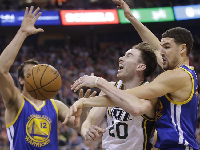 Golden State Warriors guard Klay Thompson, right, fouls Utah Jazz forward Gordon Hayward.