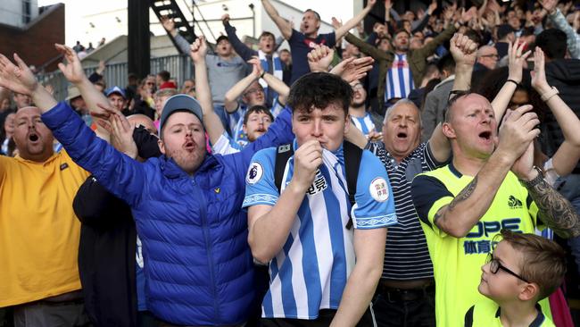 Huddersfield Town fans salute their team despite defeat to Crystal Palace confirming their relegation from the Premier League. Picture: AP