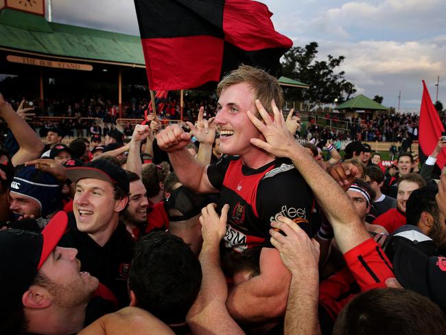 Northern Suburbs captain Will Miller is swamped by jubilant fans. Picture: Troy Snook