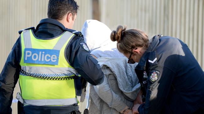 Police arrest a woman at the scene of a stabbing at Dandenong. Picture: Andrew Henshaw