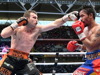 Manny Pacquiao of the Phillipines (right) is struck Jeff Horn of Australia down during the WBO World Welterweight Title fight at Suncorp Stadium in Brisbane, Sunday, July 2, 2017. (AAP Image/Dave Hunt) NO ARCHIVING, EDITORIAL USE ONLY