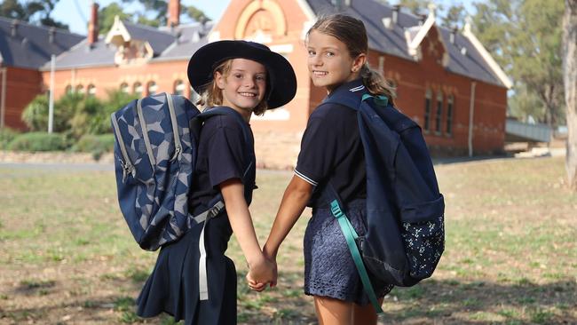 Happy students Alice, 8, and Essie, 10, are kitted out ready for the new school year. Picture: Alex Coppel.