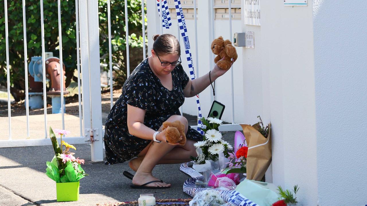 Tributes have been laid at the Thorneside unit complex, where a ferocious townhouse fire claimed the life of eight-year-old Raven Contini, while her babysitter remains missing. Picture: NewsWire/Tertius Pickard