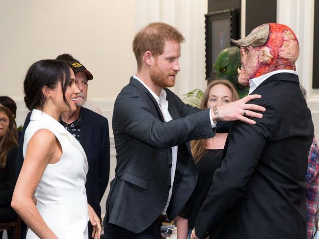 Harry and Meghan meet an actor dressed as orc at Wellington’s Courtenay Creative. Picture AFP