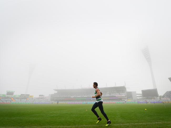 Cats player Daniel Menzel trains in the fog at Geelong. Picture: Mitch Bear