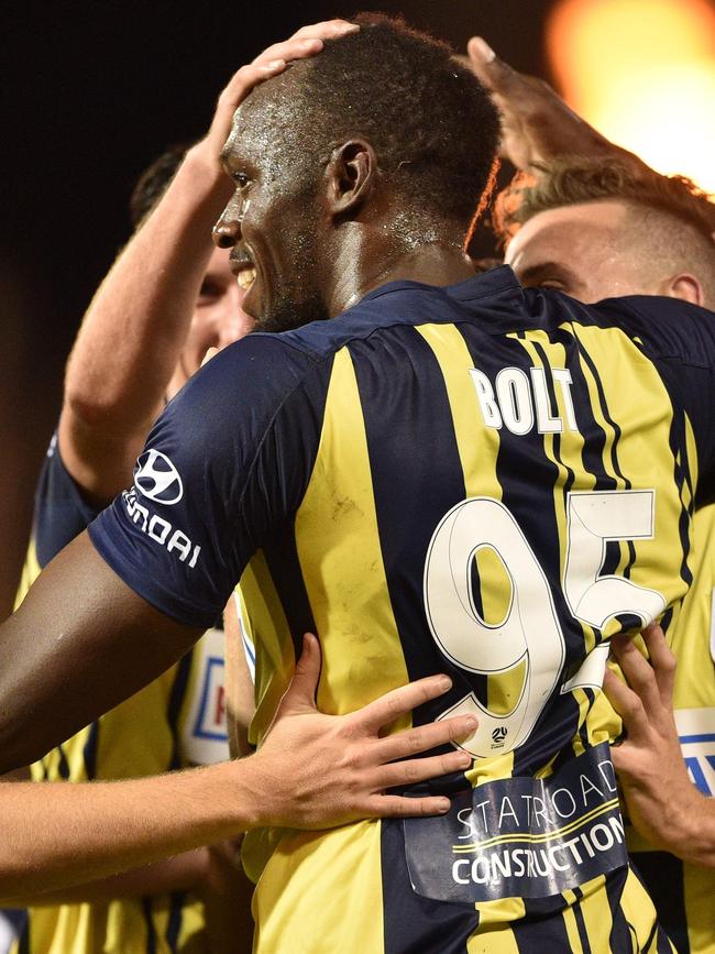 Usain Bolt celebrates with teammates after scoring his first goal. Picture: AFP Photo