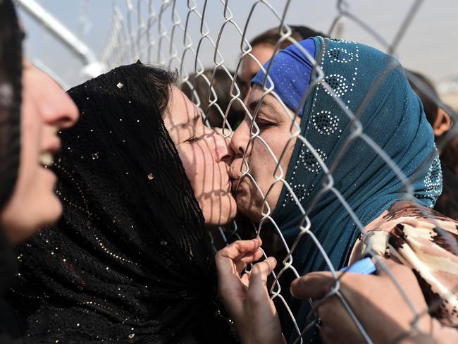 Newly displaced Iraqi’s who fled from the city of Mosul, Iraq’s last major Islamic State (IS) group stronghold, are reunited with their relatives who came two years ago to the refugee camp in the Khazir area, near near the Kurdish checkpoint of Aksi Kalak, some 40 kilometres east of Arbil following their arrival on October 26, 2016. Picture: AFP PHOTO / BULENT KILIC