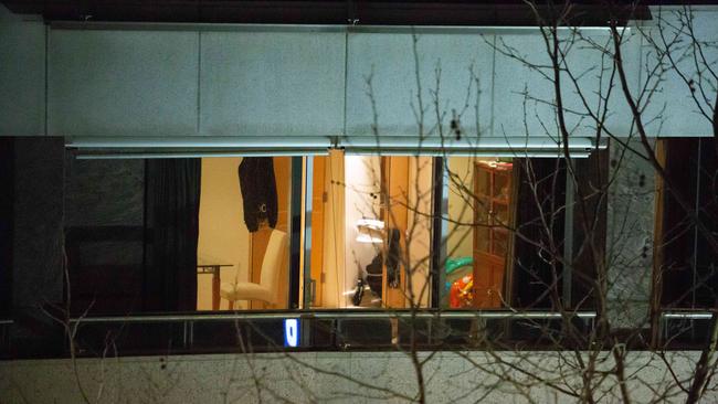 Police search an apartment on Macquarie Street last night.