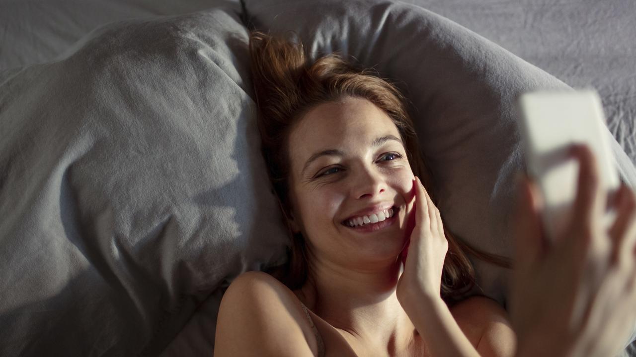A survey has found that scrolling on their phones in bed is stopping them from sleeping. Picture: iStock