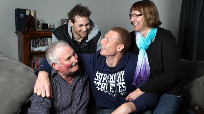 Sam Jacobs with parents Corrine and John with late brother Aaron. Picture: Sarah Reed