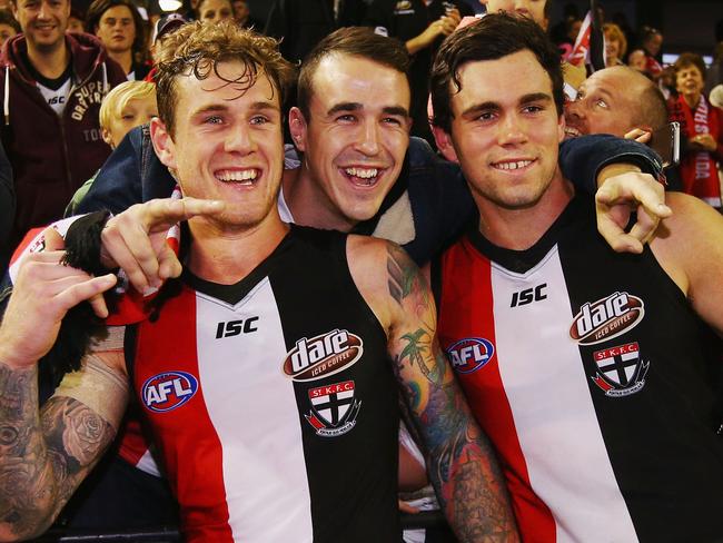 Tim Membrey of the Saints (L) and Paddy McCartin celebrate the win with a fan.