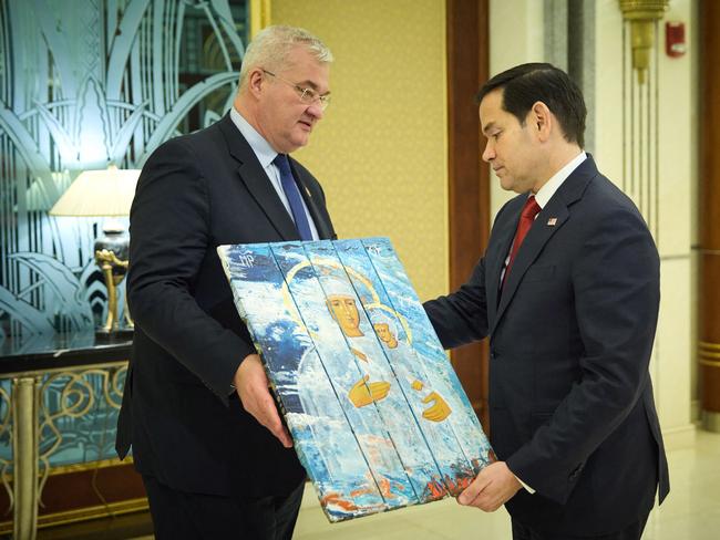 Ukraine’s Foreign Affairs Minister Andrii Sybiha holding a religious icon painted on a box intended for ammunition as he speaks with US Secretary of State Marco Rubio during the Ukrainian and US delegations meeting in Jeddah. Picture: AFP