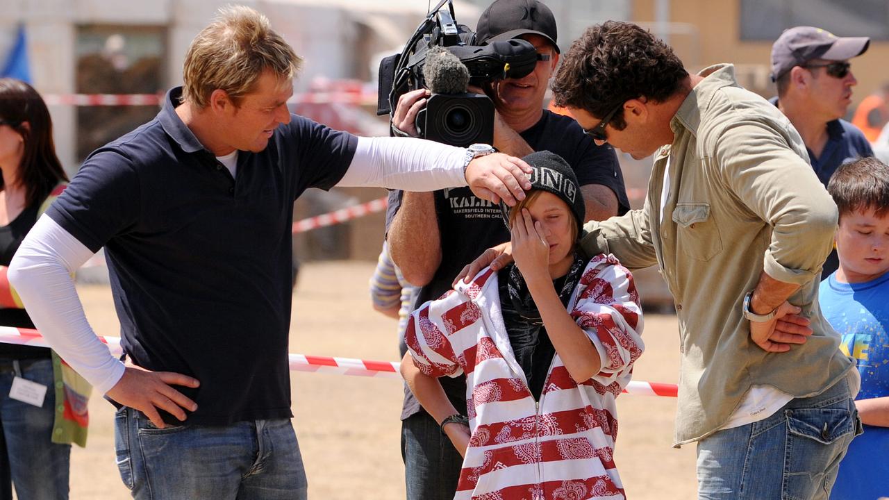 Shane Warne and an emotional Aiden Buchanan when they first met a month after the 2009 bushfires.