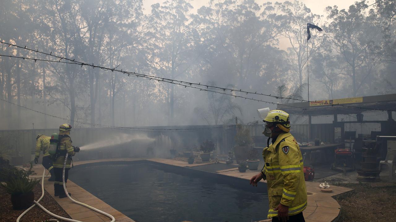 Firefighters use pool water to help save a house on Bullocky Way, Possum Brush, south of Taree. Picture: AAP