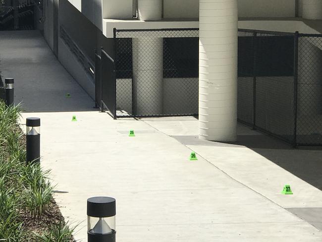 Markers indicating blood drops near the scene of the crime. Picture: Wes Hosking