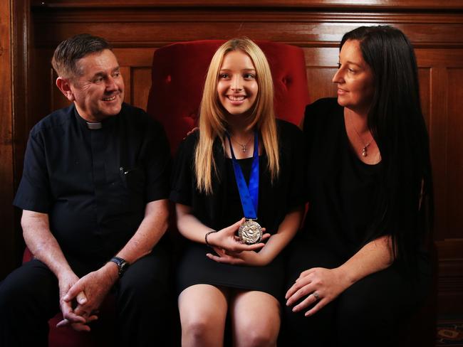 Lilly Lyons, 14, (C) with her mother Kim Kamara and Father Chris Riley. Lilly was a victim of sexual abuse when younger and has dedicated her spare time to making the world a better place for youngsters everywhere. Picture: Toby Zerna