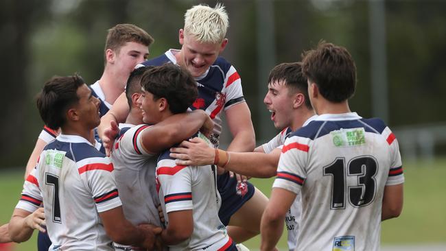 The Roosters celebrate a try. Picture: Sue Graham