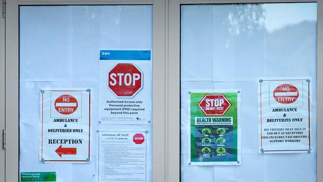 The doors at Glenlyn Aged Care are plastered with warning signs. Picture: Mark Stewart