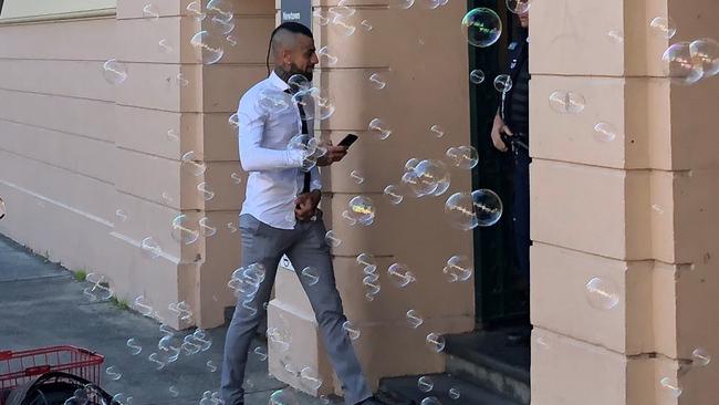 Ben Gittany at Newtown Local Court on Friday. A bubble machine was set up by supporters of the homeowner and artist outside the courthouse.