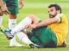 Australia's captain Mile Jedinak (R) injures his ankle against Kuwait as teammate Tim Cahill (L) looks on during the opening football match of the AFC Asian Cup in Melbourne on January 9, 2015. AFP PHOTO / William WEST --IMAGE RESTRICTED TO EDITORIAL USE - STRICTLY NO COMMERCIAL USE--