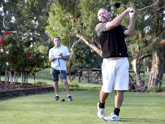 GOLF - Golfers still keen to play on despite the different rules in place at different clubs due to Coronavirus. Willunga Golf Club is open for business. Mark McPherson from McLaren Vale (blue Shirt) and Brenton Irving from Seaford (black top) Picture SARAH REED