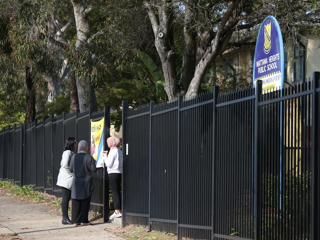 Shocked parents arriving at Wattawa Heights Public School today. Picture: Richard Dobson