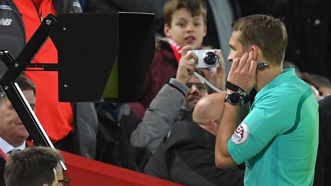 Referee Craig Pawson looks at the VAR screen after awarding Liverpool a penalty in their FA Cup fourth round clash with West Brom in November. Picture: AFP 