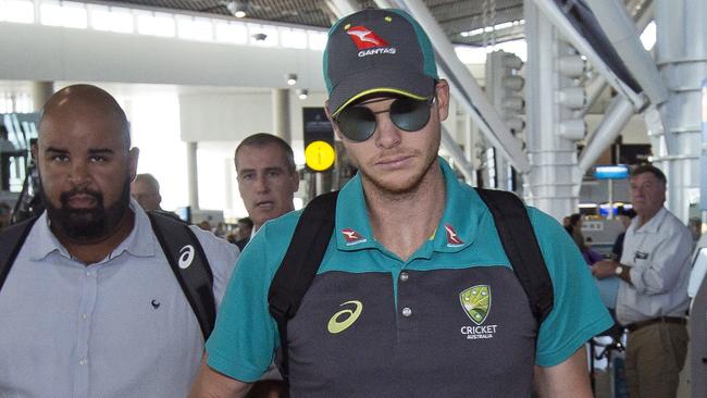 Australian cricket captain Steve Smith arrives with teammates, at the Cape Town International airport as they depart to Johannesburg for the final five day cricket test match, in Cape Town, South Africa, Tuesday, March 27, 2018. Smith has been suspended by the International Cricket Council for the match for his part in a ball tampering scandal during the third test. Smith admitted some senior players were aware of the tampering attempt. (AP Photo/Halden Krog)