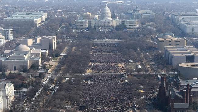 This pair of photos shows a view of the crowd on the National Mall at the inaugurations of President Barack Obama, above, on Jan. 20, 2009 ...