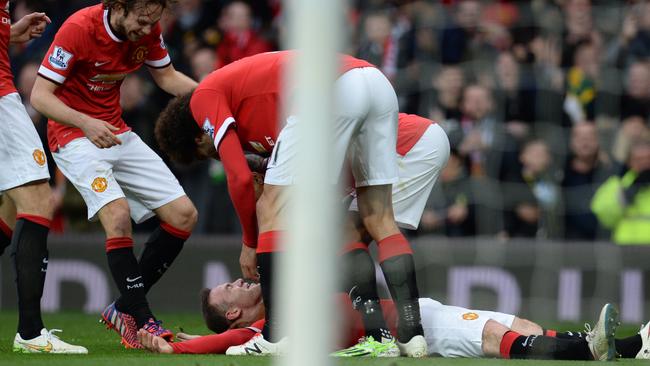 Manchester United's English striker Wayne Rooney pretends to be knocked down.