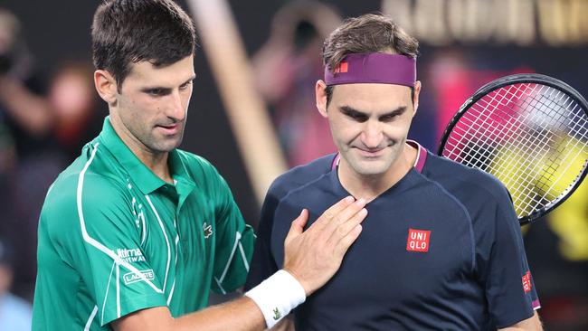 Novak Djokovic pats Roger Federer after his victory during their men's singles semi-final match of the Australian Open in 2020. Picture: David Gray/AFP