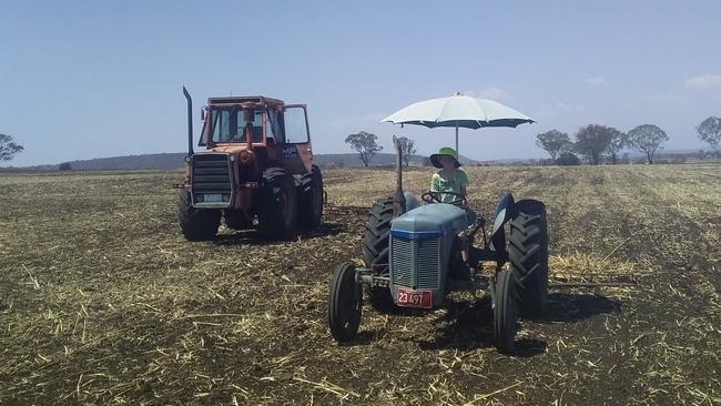 Sixth generation Cameron Mengel driving his tractor on the farm.