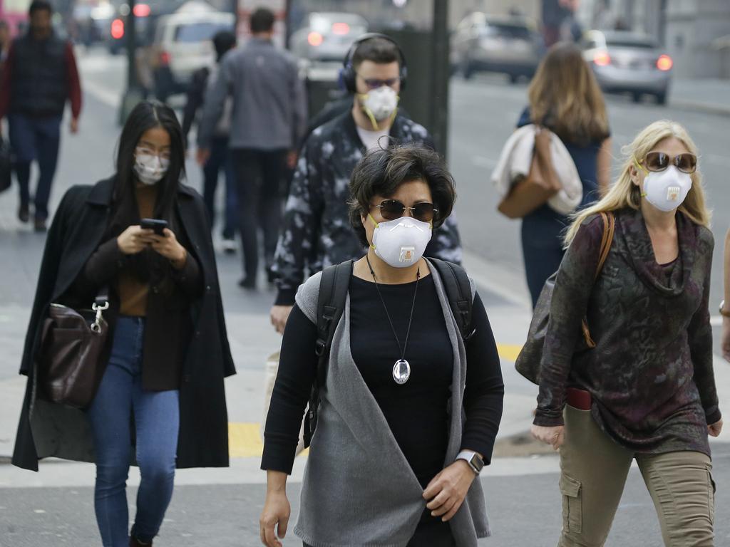 People wear masks while walking through the Financial District in the smoke-filled air in San Francisco. Picture: AP