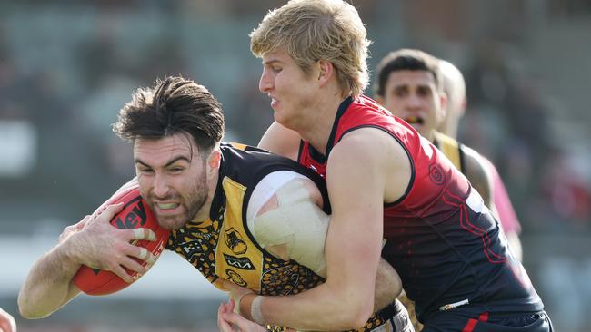 Six-goal Tigers star Liam McBean is tackled by Norwood opponent Jack Heard at The Parade. Picture: David Mariuz (SANFL)