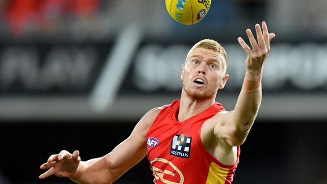 Peter Wright of the Suns in action during the AFL Marsh Community Series pre-season match between the Gold Coast Suns and Geelong Cats at Metricon Stadium on the Gold Coast, Saturday, February 22, 2020. (AAP Image/Darren England) NO ARCHIVING, EDITORIAL USE ONLY