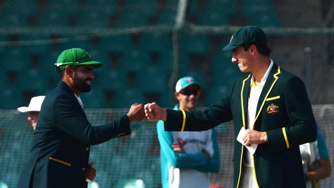 Pakistan's captain Babar Azam, left, and his Australian counterpart Pat Cummins bump fists after the toss before the start of the first day play of the second Test cricket match between Pakistan and Australia in Karachi on March 12. Picture: AFP