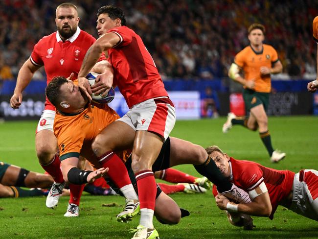 Wales' right wing Louis Rees-Zammit (C) collides with Australia's prop Angus Bell during the Rugby World Cup 2023 match between Wales and Australia. Picture: Sebastien Bozon/AFP