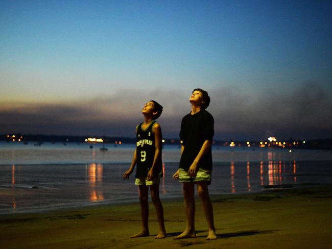 A classic NT scene: Kids, a peaceful beach and exploding stuff in the sky.