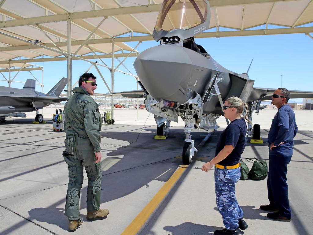 Australian Pilots training in the F35 fighter Jets Luke Airforce Base in Phoenix Arizona. Squadron leader call sign “Belly” talks to RAAF Corp Lorna Hill who is part of the maintenance and ground crew team before a flight. Picture: Nathan Edwards