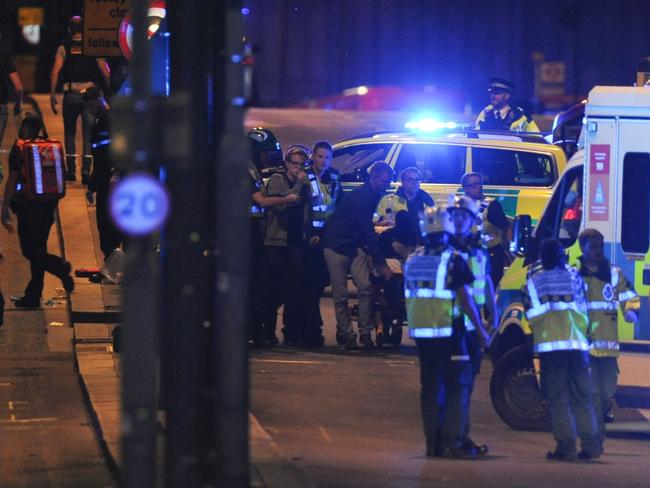 Police officers and members of the emergency services attend to persons injured in an apparent terror attack on London Bridge. Picture: AFP