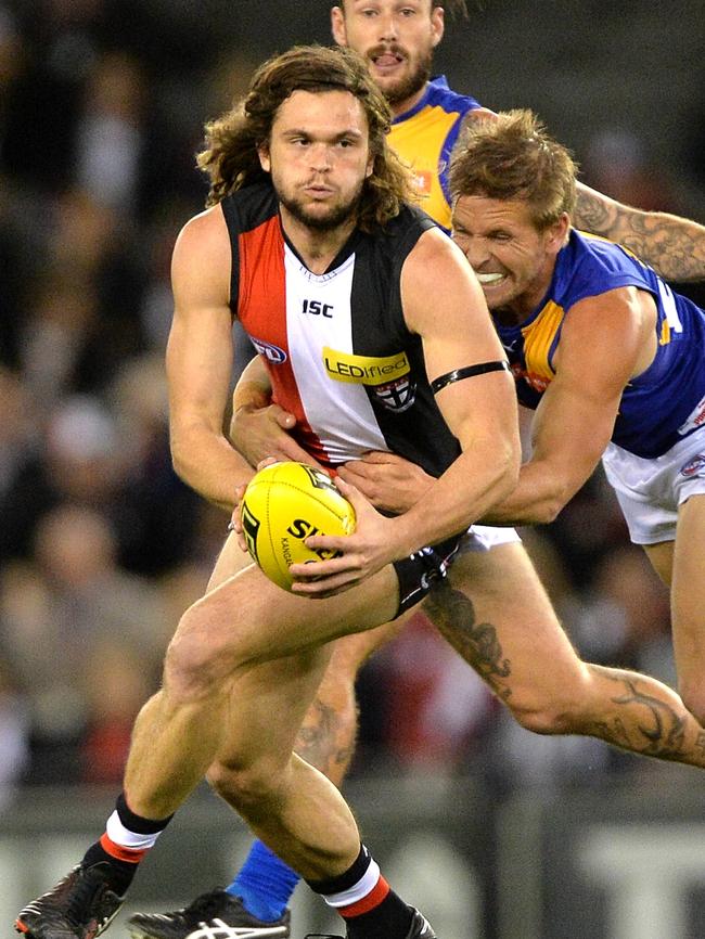 Cameron Shenton is tackled by West Coast’s Mark LeCras while playing for the Saints in 2014. Picture: Jay Town