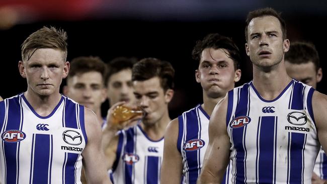 MELBOURNE, AUSTRALIA - MAY 23: Dejected North Melbourne players walk off the ground after the round 10 AFL match between the Essendon Bombers and the North Melbourne Kangaroos at Marvel Stadium on May 23, 2021 in Melbourne, Australia. (Photo by Darrian Traynor/Getty Images)