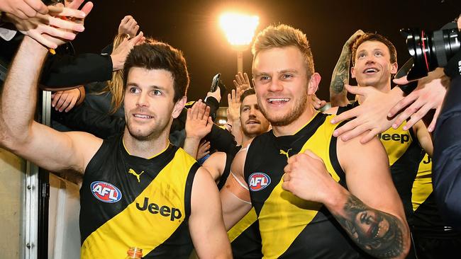 Brandon Ellis walks off the MCG all smiles with skipper Trent Cotchin after the Tigers’ win over Geelong. Picture: Getty Images