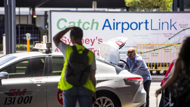 Taxi drivers pick up passengers from Sydney International Airport taxi rank. Photo Jeremy Piper