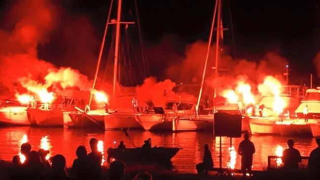 Flares are let off from a flotilla of boats moored in the Broadwater, signalling the start of the Southport Dawn Service. Photo: Michelle Green