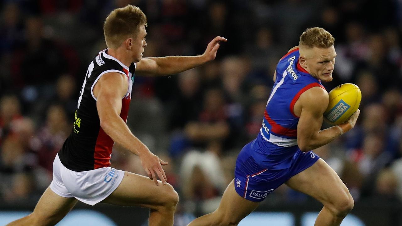 MELBOURNE, AUSTRALIA - MAY 22: Adam Treloar of the Bulldogs is tackled by Sebastian Ross of the Saints during the 2021 AFL Round 10 match between the Western Bulldogs and the St Kilda Saints at Marvel Stadium on May 22, 2021 in Melbourne, Australia. (Photo by Michael Willson/AFL Photos via Getty Images)