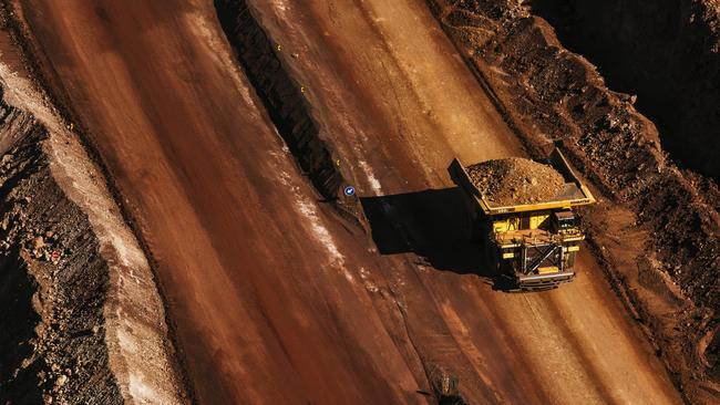 A dumper truck carries excavated iron ore from the iron ore pit at the Sishen open cast mine, operated by Kumba Iron Ore Ltd, an iron ore-producing unit of Anglo American. Picture: Bloomberg