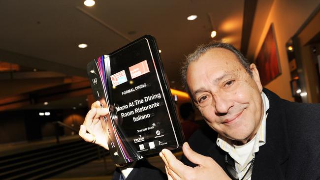 Mario Alfieri with an award for his restaurant Mario At The Dining Room.